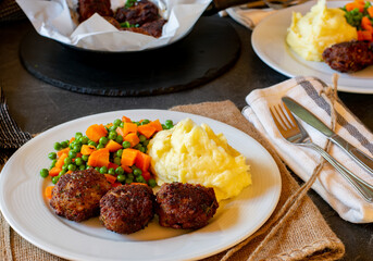 meatballs with peas and carrots and mashed potatoes