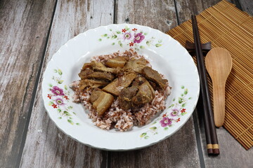 Grilled mixed pork belly and chicken meat serving with cooked rice on the plate. Famous traditional street food in Asia. Food in rush hour concept. 