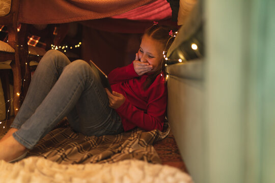 Caucasian girl laughing and using tablet computer - Powered by Adobe