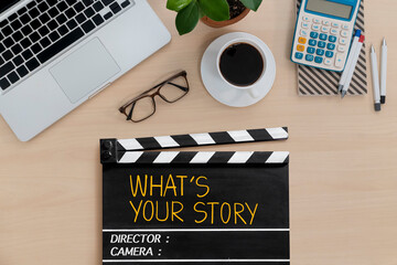 What's your story.text title on film slate on work table.