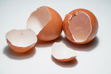 Broken egg on top against white background