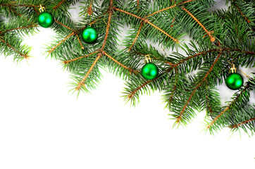 Fir branches and Christmas decorations on a white background.