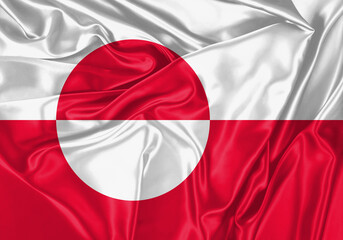 Greenland flag waving in the wind. National flag on satin cloth surface texture. Background for international concept.