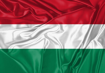 Obraz premium Hungary flag waving in the wind. National flag on satin cloth surface texture. Background for international concept.
