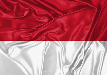 Monaco flag waving in the wind. National flag on satin cloth surface texture. Background for...