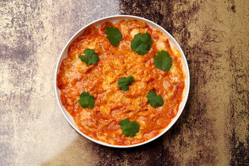 Fried eggs with tomatoes. Omelette on breakfast table
