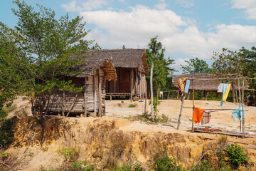 Traditional wooden african malagasy hut with roof from straw, typical village in north west Madagascar. Madagascar landscape. © ArtushFoto