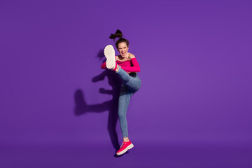 Obraz na płótnie Canvas Full length body size view of strong cheerful girl fighting invisible enemy judo art isolated bright violet color background