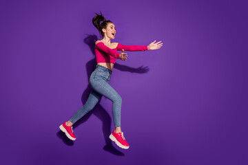 Fototapeta na wymiar Full length body size view of kind slim cheerful girl jumping running hugging invisible people isolated bright violet color background