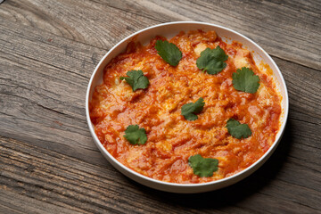 Fried eggs with tomatoes. Omelette on breakfast table