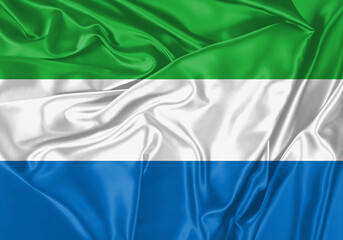 Sierra Leone flag waving in the wind. National flag on satin cloth surface texture. Background for...