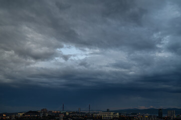 Fototapeta premium Cityscape with dark moody sky.