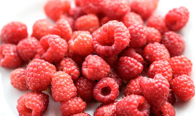 Heap of raspberries on the white background.