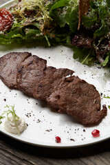 Grilled beef steak with fresh salad. Roasted meat steak