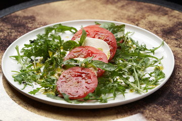 Italian caprese salad with sliced tomatoes, mozzarella