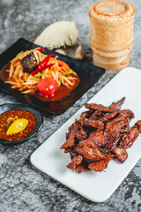 deep fried sun-dried pork (Moo dad deaw) with papaya salad(som tum), Thai food