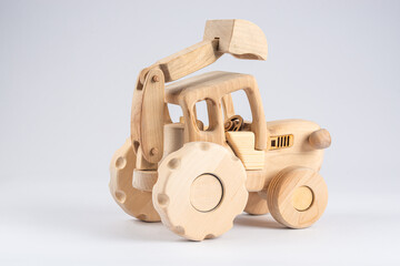 wooden kids tractor toy with trailer isolated on white background, close view 
