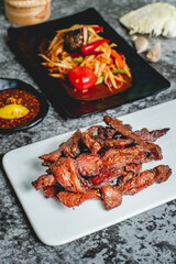 deep fried sun-dried pork (Moo dad deaw) with papaya salad(som tum), Thai food