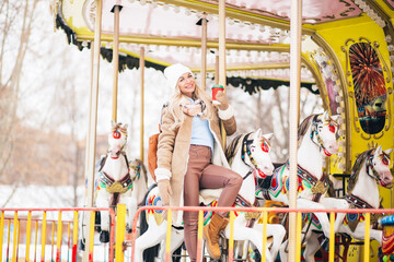 Outdoor photo of happy girl in amusement park in winter