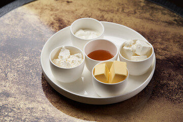 Healthy breakfast set on table with honey, tea, bread