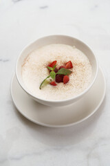 Oatmeal porridge with strawberry, raspberry and mint