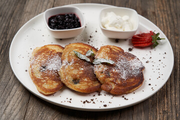 Pancakes with fresh berries and jam. Healthy breakfast table