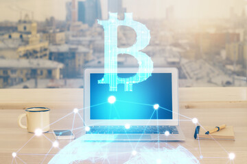 Double exposure of blockchain theme hologram and table with computer background. Concept of bitcoin crypto currency.