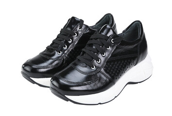 Black shiny patent leather women's sneakers with white sole isolated on a white background.