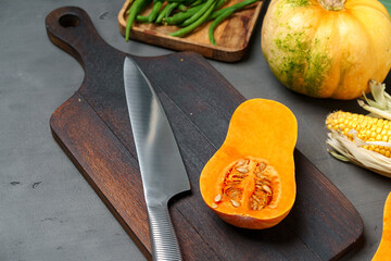 Close up photo of pumpkin on dark cooking table