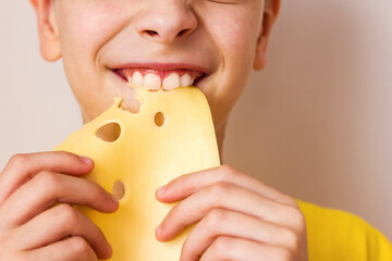 Boy biting a piece of cheese portrait close-up	