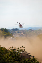 Helicopter coming to rescue kicking up dust from turbulence