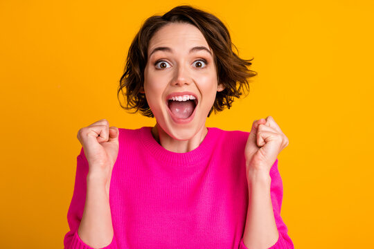 Close up photo of delighted girl raise fists scream wear pullover isolated over vivid color background
