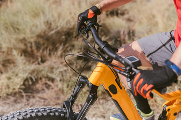 cyclist holds handlebar with hands