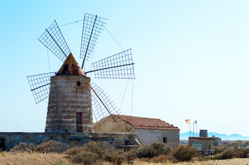 One of the many wind mill of the Trapani's salt pans with its characteristic red roof
