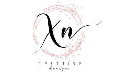 Handwritten XN X N letter logo with sparkling circles with pink glitter.