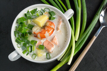 Salmon soup with cream, potatoes, carrots and dill.