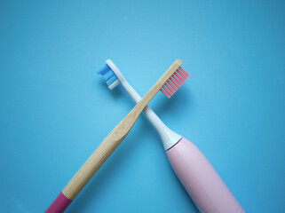 two ultrasonic electric toothbrushes on a blue background