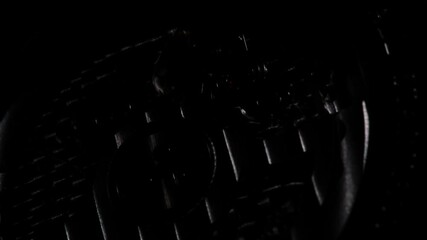 Back view of luxury swiss watch with full open mechanism. Clock gears running with dramatic flickering light. Extreme closeup