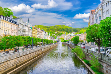 Karlovy Vary (Carlsbad) historical city centre with Tepla river central embankment, colorful...
