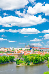 Fototapeta na wymiar Aerial vertical view of Prague city, historical center with Prague Castle, St. Vitus Cathedral in Hradcany district, Strelecky island, Vltava river, blue sky white clouds, Bohemia, Czech Republic