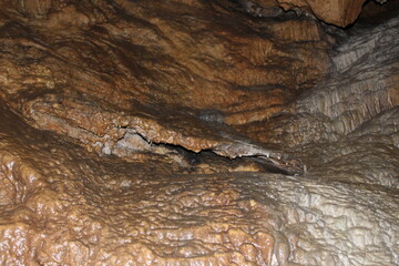 Crimea / Russia. red cave inside. Stalactites and stalagmites