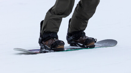 Snowboarder rides on a board in the snow