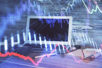 Financial market graph hologram and personal computer on background. Double exposure. Concept of forex.
