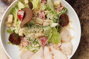 Caesar Salad with grilled chicken breast and parmesan cheese