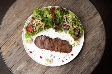 Grilled beef steak with fresh salad. Roasted meat steak