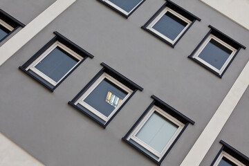 Fototapeta na wymiar Building facade with square windows and sky