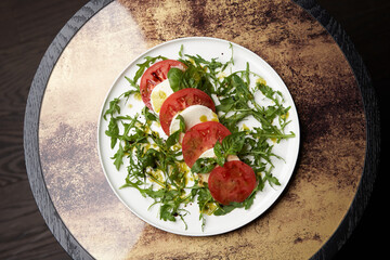 Italian caprese salad with sliced tomatoes, mozzarella