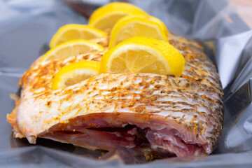 Large river fish Bream with spices and lemon slices