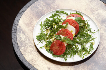 Italian caprese salad with sliced tomatoes, mozzarella