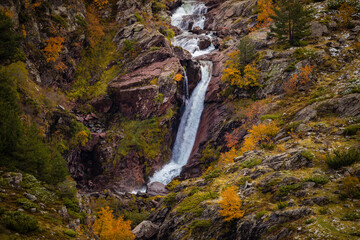 Cascade of cold and icy water from the Aragon Subordan River, near its source. Aragonese Pyrenees, near of Aguas Tuertas valley, Hecho and Anso, Huesca, Spain.